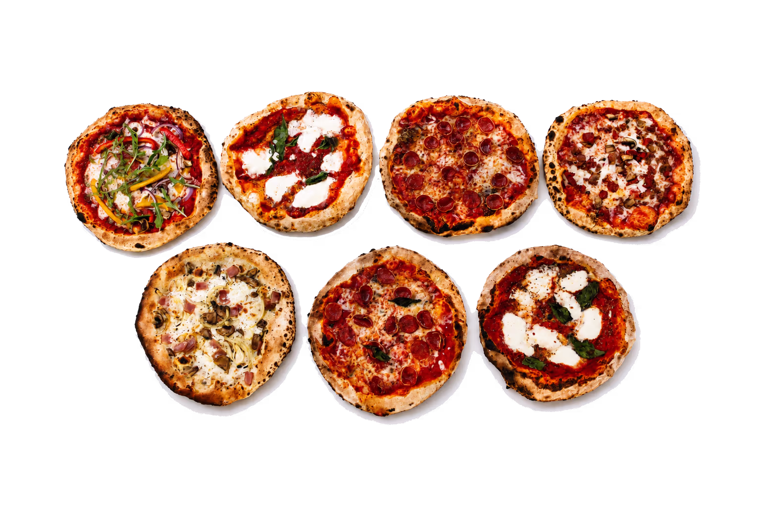 Variety of wood-fired pizzas arranged for buffet service